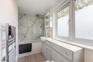 a bathroom with a sink and a tub and a window at 2 Bed in Battle oc-m31780 in Battle +11 photos