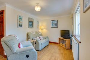 a living room with two chairs and a tv at 1 Bed in Robeston Wathen oc-pw9200 in Robeston Wathen