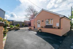 a small pink house with a driveway at 1 Bed in Robeston Wathen oc-pw9200 in Robeston Wathen