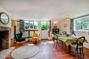 a living room with a table and chairs and a fireplace at 2 Bed in Ilketshall St. Margaret oc-w27520 in Rumburgh