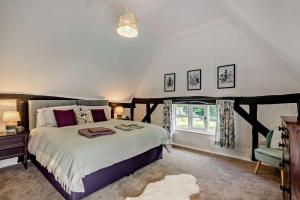 a bedroom with a large bed and a window at 2 Bed in Ilketshall St. Margaret oc-w27520 in Rumburgh