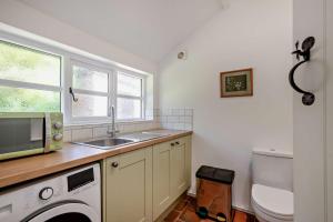 a kitchen with a sink and a washing machine at 2 Bed in Ilketshall St. Margaret oc-w27520 in Rumburgh +7 photos