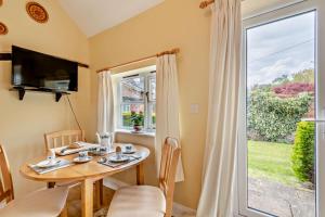 a dining room with a table and a window at 1 Bed in Barton Turf oc-s29126 in Neatishead