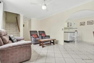a living room with two chairs and a couch and a table at Crystal Waters-2 bed, 2 bathroom, Beachfront Unit! in Bongaree