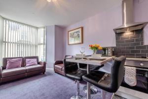 a living room with a table and a couch at 2 Bed in Tenby oc-w28987 in Tenby +17 photos