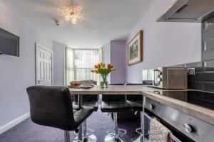 a kitchen with a table and chairs in a room at 2 Bed in Tenby oc-w28987 in Tenby