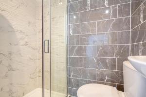 a bathroom with a shower with a toilet and a sink at 3 Bed in Llysfaen oc-t32226 in Llysfaen +22 photos