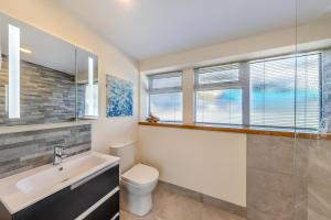 a bathroom with a sink and a toilet and a window at 2 Bed in Aberdovey oc-n30627 in Aberdyfi +24 photos