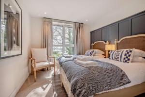 a bedroom with a large bed and a chair at 2 Bed in Padstow oc-h29015 in Padstow