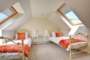 two beds in a attic bedroom with skylights at 5 Bed in Amroth oc-pw9068 in Amroth