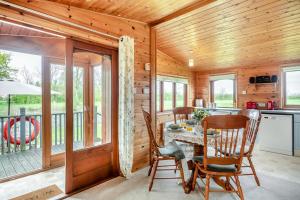 a dining room with a table and chairs in a cabin at 2 Bed in Otley oc-slm in Burgh