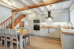 a kitchen with white cabinets and a wooden table at 3 Bed in Pickering oc-t33630 in Pickering