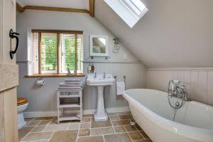 a bathroom with a white tub and a sink at 1 Bed in Wadhurst oc-tw668 in Ticehurst +20 photos