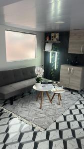 a living room with a couch and a table at Apartamento en Itagüí in Itagüí +11 photos