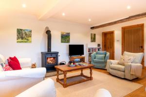 a living room with a fireplace and a tv at 3 Bed in Wadhurst oc-tw665 in Wadhurst