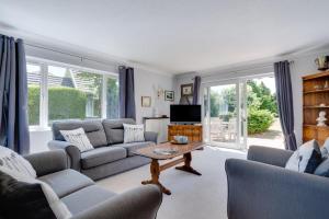 a living room with a couch and a table at 3 Bed in Aldeburgh oc-10nw in Aldeburgh