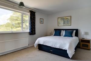 a bedroom with a large bed and a window at 3 Bed in Aldeburgh oc-10nw in Aldeburgh