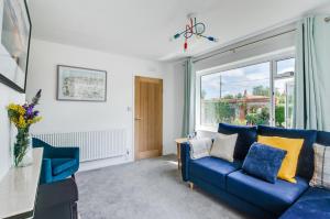 ein Wohnzimmer mit einer blauen Couch und einem Fenster in der Unterkunft 2 Bed in Docking oc-2212 in Docking