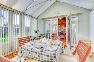a dining room with a table and chairs and windows at 2 Bed in Briston oc-1551 in Briston