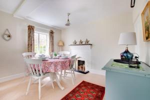 a dining room with a table and chairs and a fireplace at 2 Bed in Ufford oc-sfmcu in Ufford +5 photos
