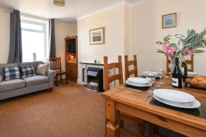 a living room with a table and a couch at 4 Bed in Bwlchtocyn oc-uchaf in Abersoch