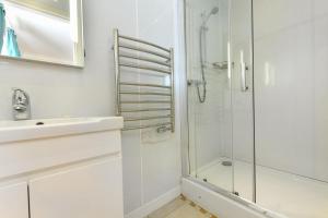 a bathroom with a glass shower and a sink at 4 Bed in Bwlchtocyn oc-uchaf in Abersoch +18 photos