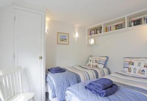a bedroom with two beds and a mirror at 2 Bed in Snape oc-sfbox in Snape