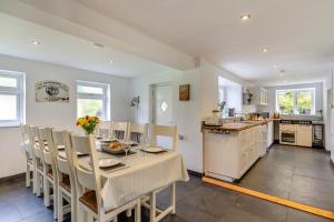 a kitchen and dining room with a table and chairs at 5 Bed in Bodmin oc-l29658 in Blisland