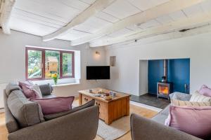 a living room with two couches and a tv at 5 Bed in Bodmin oc-l29658 in Blisland