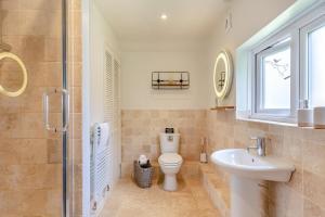 a bathroom with a toilet and a sink at 5 Bed in Bodmin oc-l29658 in Blisland +30 photos