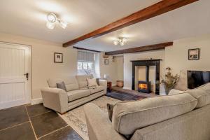 a living room with two couches and a fireplace at 4 Bed in Kinniside oc-c28854 in Frizington