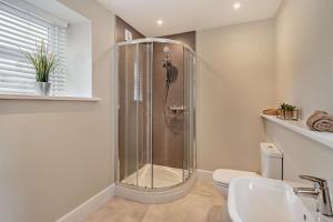 a bathroom with a shower and a toilet and a sink at 4 Bed in Kinniside oc-c28854 in Frizington +19 photos