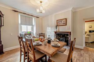 a dining room with a table and chairs and a fireplace at 4 Bed in Kinniside oc-c28854 in Frizington