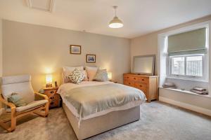 a bedroom with a bed and a chair and a window at 4 Bed in Kinniside oc-c28854 in Frizington