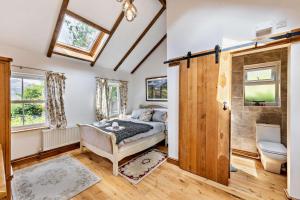 a bedroom with a bed and a bathroom at 3 Bed in Fucheswen oc-m29608 in Blaenau-Ffestiniog