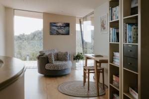 a living room with a chair and a desk at Peak View Retreat in Nelson