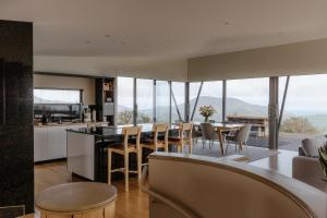 a kitchen and living room with a table and chairs at Peak View Retreat in Nelson