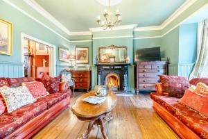a living room with a couch and a fireplace at 4 Bed in Alnmouth oc-a30221 in Alnmouth