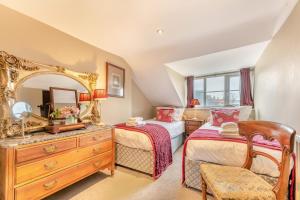 a bedroom with two beds and a large mirror at 4 Bed in Alnmouth oc-a30221 in Alnmouth