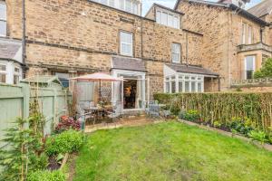 a brick building with a yard with an umbrella at 4 Bed in Alnmouth oc-a30221 in Alnmouth