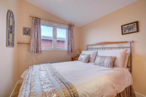 a bedroom with a large bed and a window at 2 Bed in St. Merryn oc-p00673 in Saint Merryn