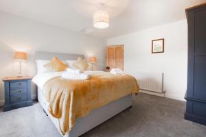 a bedroom with a large bed and a blue cabinet at 3 Bed in Askrigg oc-ds1049 in Askrigg