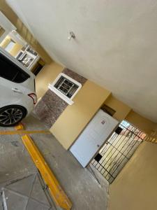a car parked in front of a house with a garage at Bohio rd in Santo Domingo