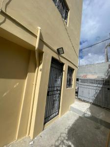 a building with a black door and a fence at Bohio rd in Santo Domingo