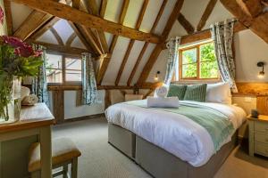 a bedroom with a large bed in a room with wooden ceilings at 5 Bed in Frampton On Severn oc-d29489 in Frampton on Severn +47 photos