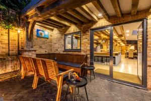 an outdoor patio with a bench and a table at 5 Bed in Frampton On Severn oc-d29489 in Frampton on Severn