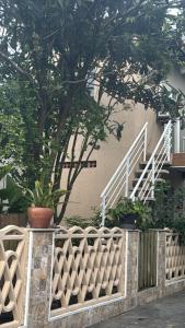 a fence with a staircase in front of a building at Casa em Mongaguá in Mongaguá