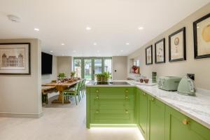 a kitchen with green cabinets and a dining room at 3 Bed in Westmancote oc-t30722 in Kemerton