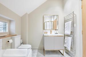 a white bathroom with a toilet and a mirror at 3 Bed in Westmancote oc-t30722 in Kemerton +22 photos
