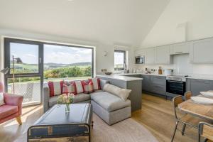 a kitchen and living room with a couch and a table at 2 Bed in Newburgh oc-g32594 in Newburgh